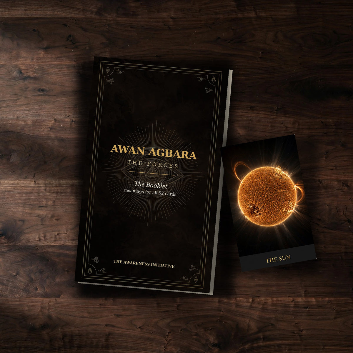 AWAN AGBARA companion booklet with The Sun card on dark wood